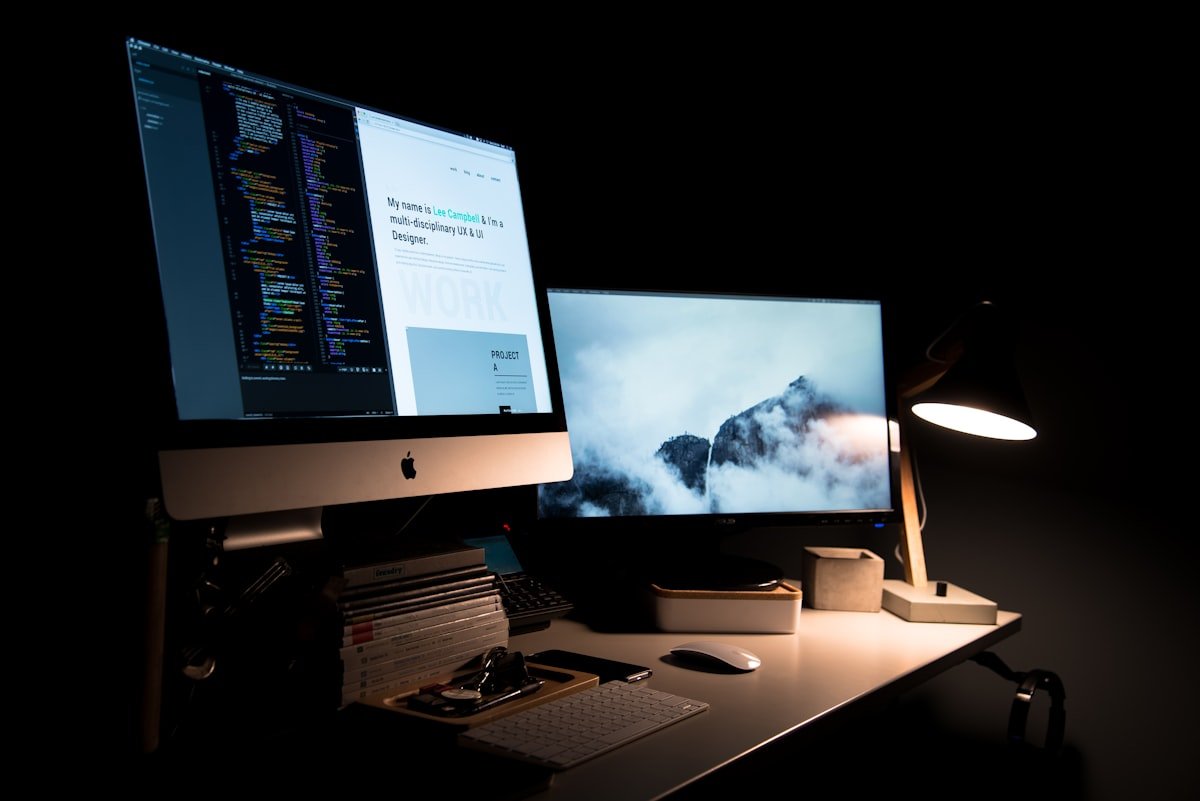 Creative web designer reviewing client website designs and layout wireframes on screen